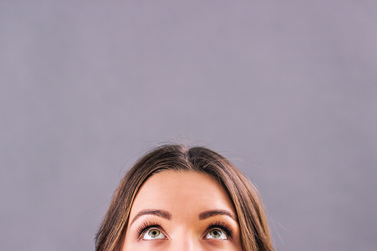 attractive funny girl staring above her head