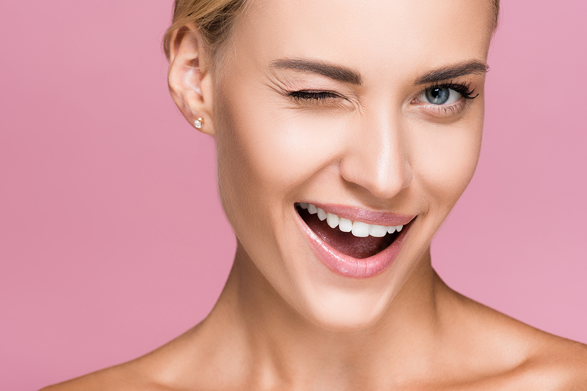beautiful blonde woman with perfect skin winking