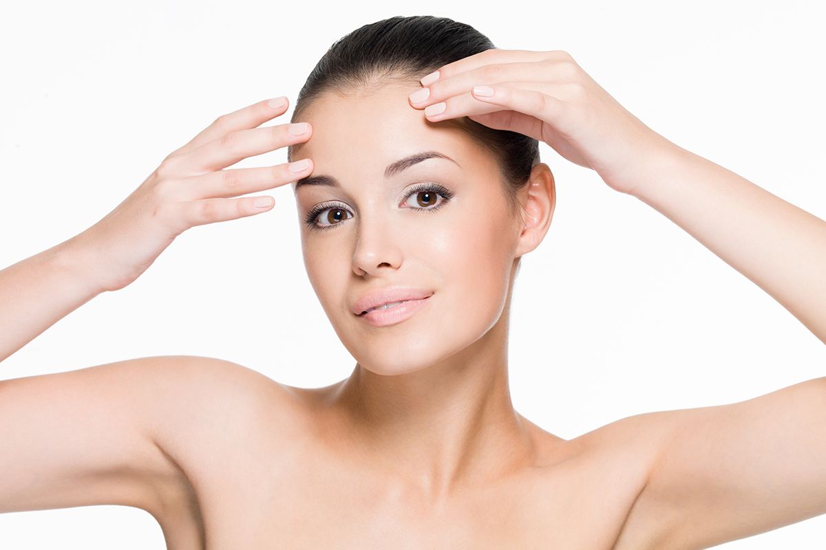 beautiful woman cares of forehead