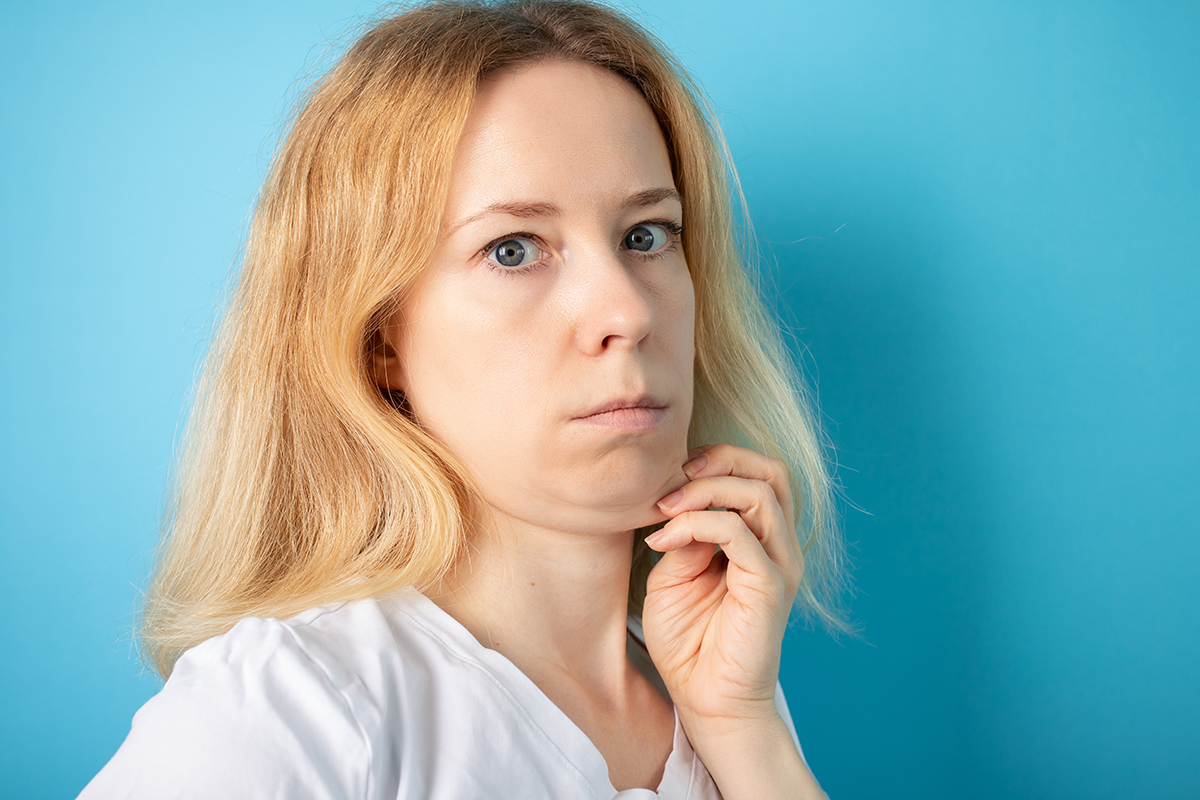 double chin woman holding facial skin