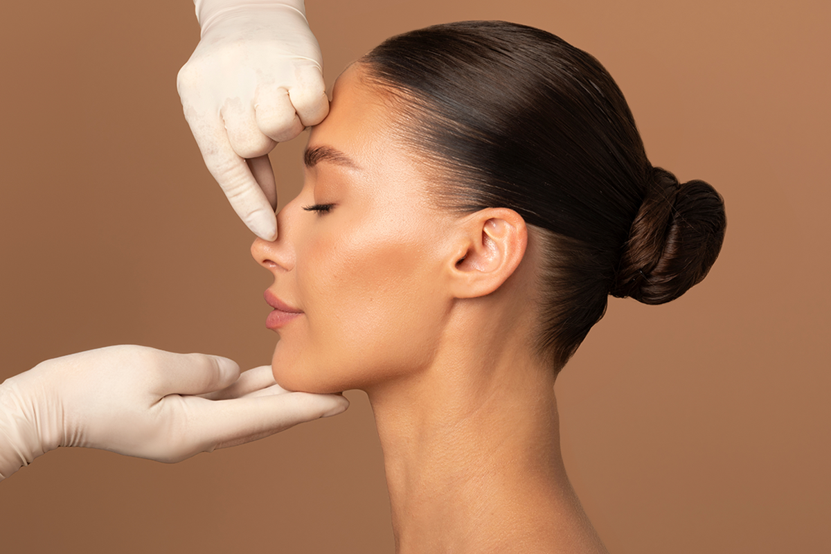 surgeon touching woman nose