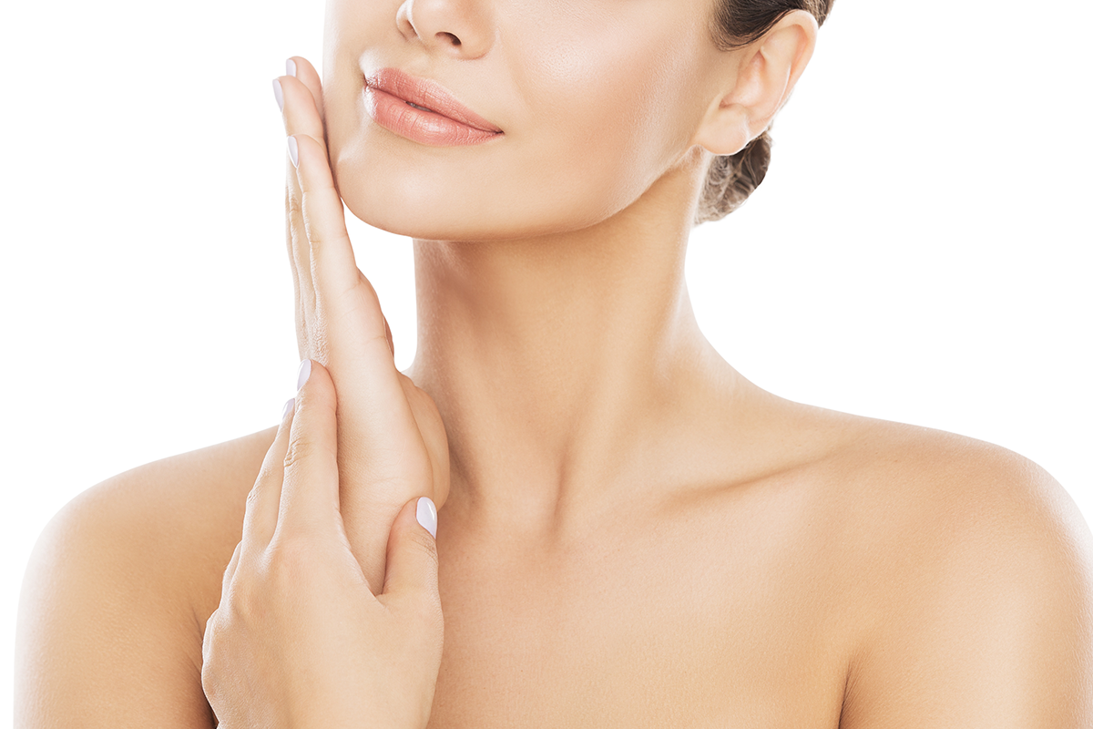 woman moisturizing and massaging cheek by hand