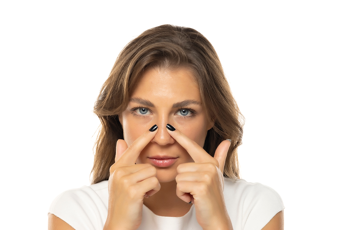 young woman touches her nose with her fingers
