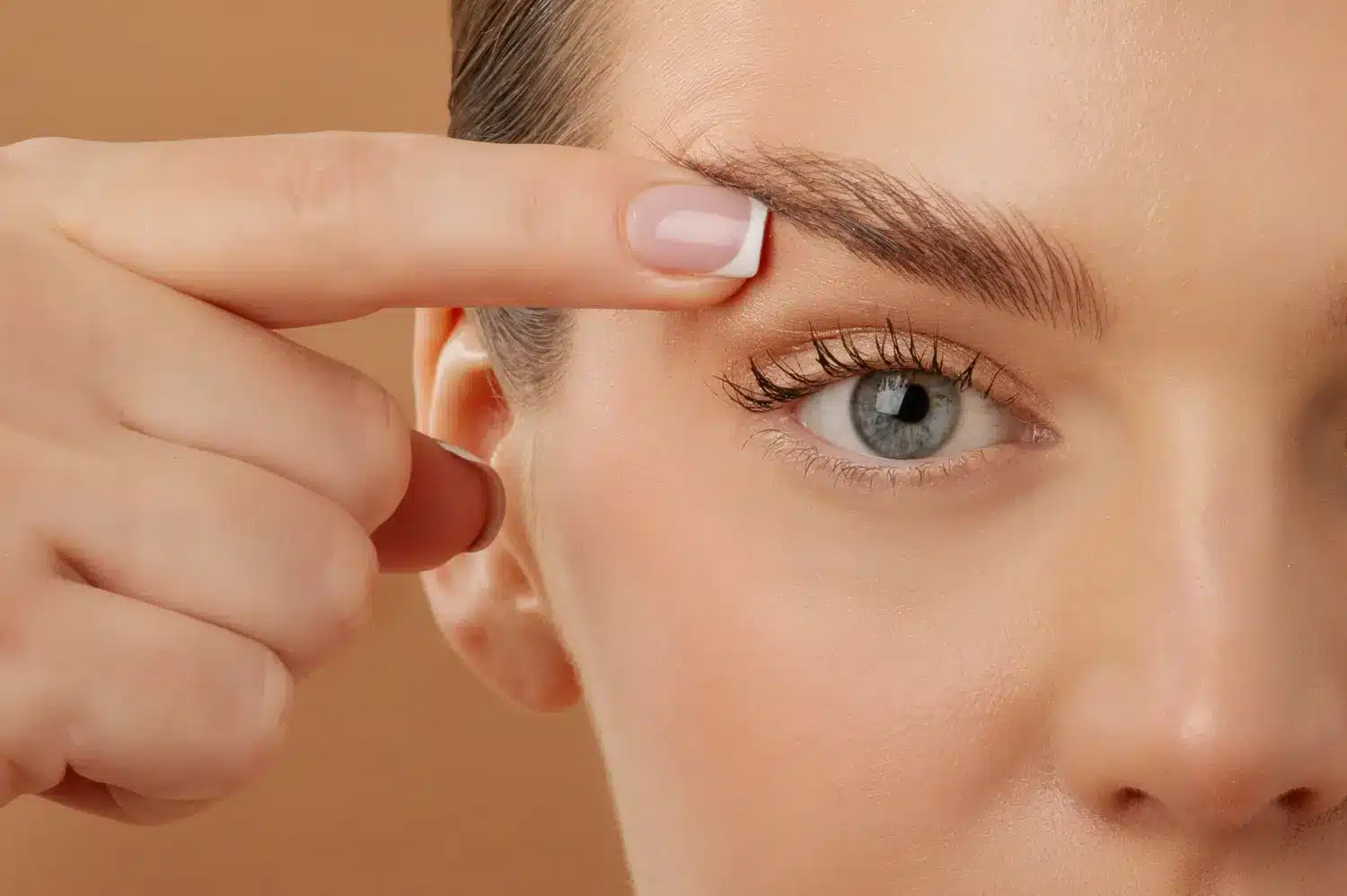 Blepharoplasty. Woman touching eyelid skin