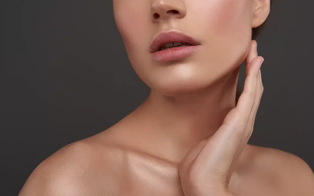 beautiful young woman with radiant skin touching her neck
