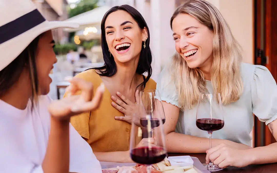group of young woman happy laughing drinking wine