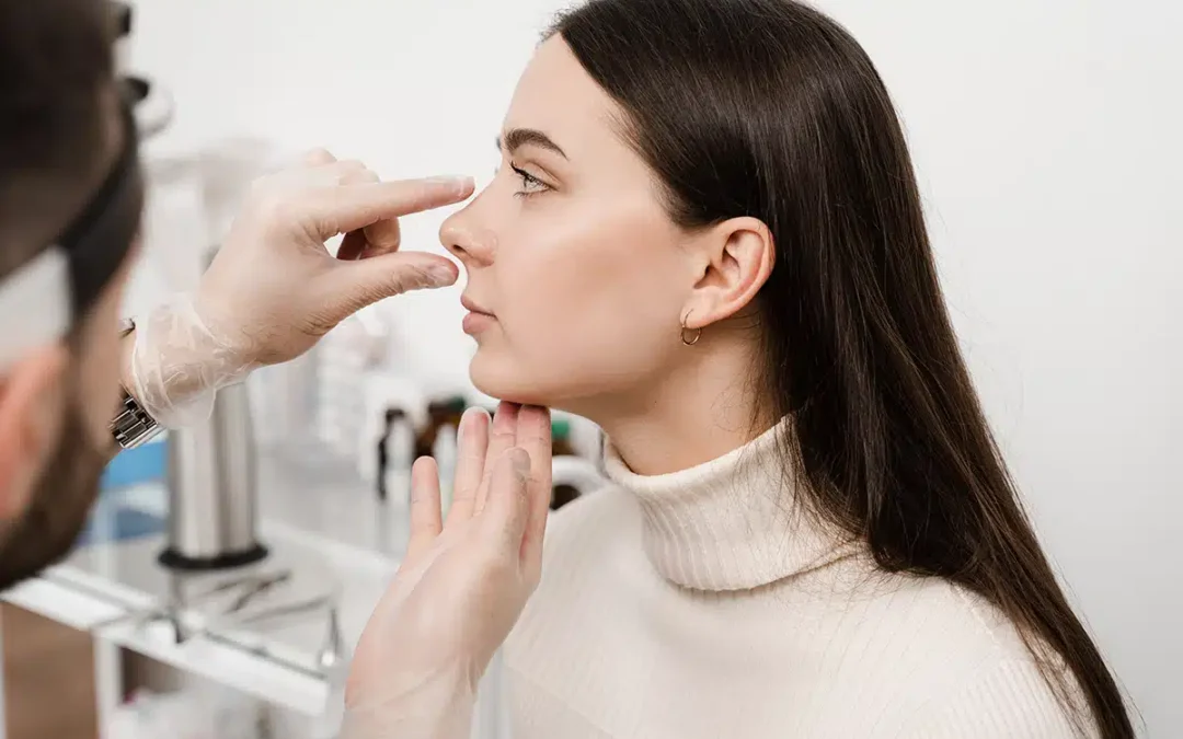 plastic surgeon examining patients nose