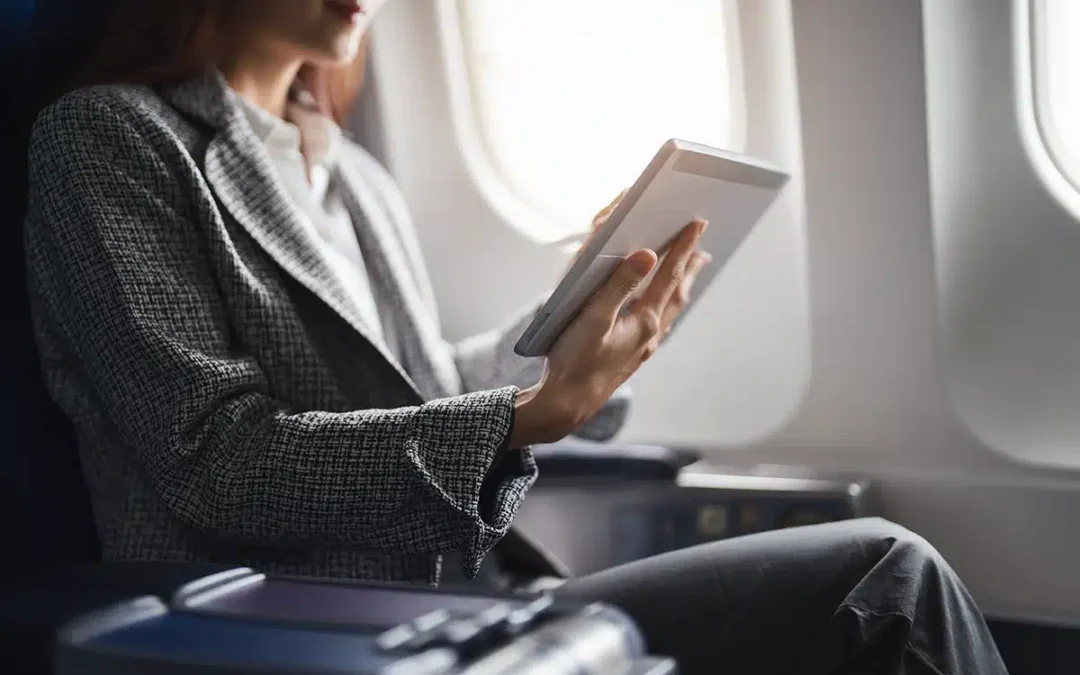 woman using tablet on plane